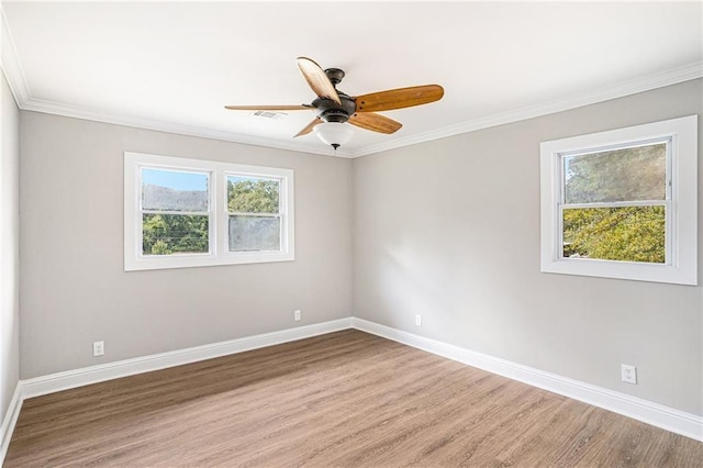 unfurnished room with baseboards, visible vents, and a healthy amount of sunlight