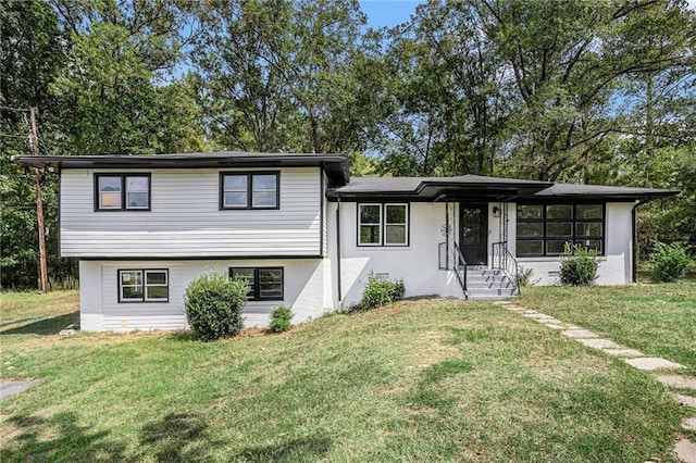 split level home with a front lawn