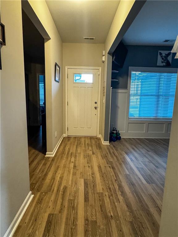 foyer entrance with hardwood / wood-style floors and a wealth of natural light