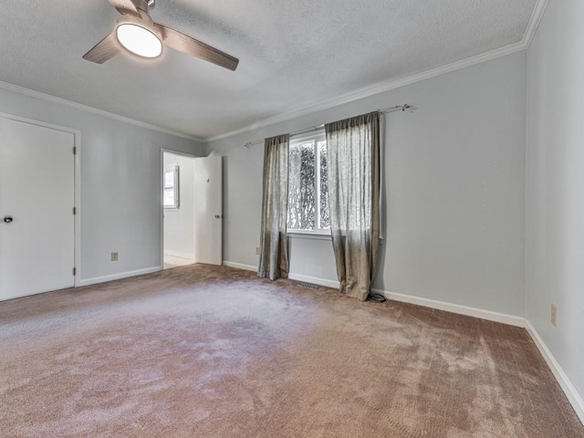 unfurnished room featuring carpet flooring, ceiling fan, ornamental molding, and a textured ceiling