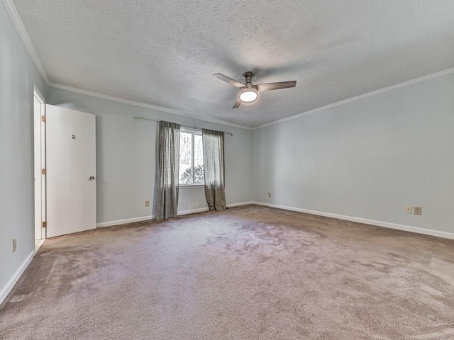 spare room with carpet flooring, a textured ceiling, ceiling fan, and crown molding