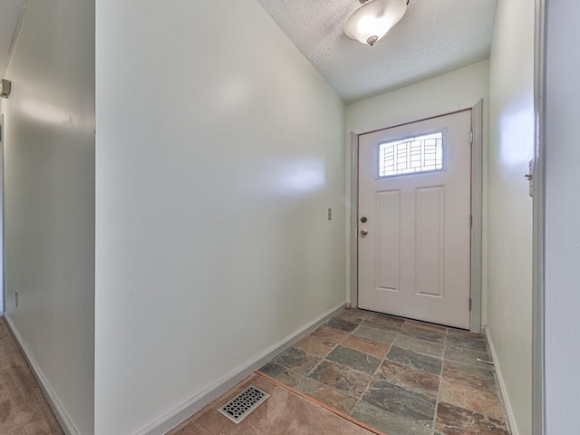 entryway featuring a textured ceiling