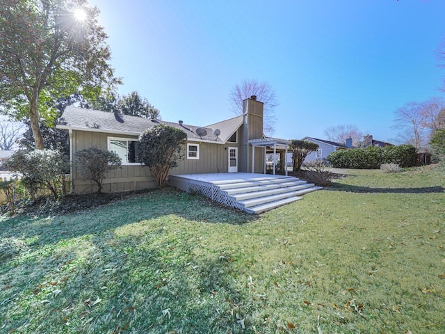 rear view of house with a yard and a patio