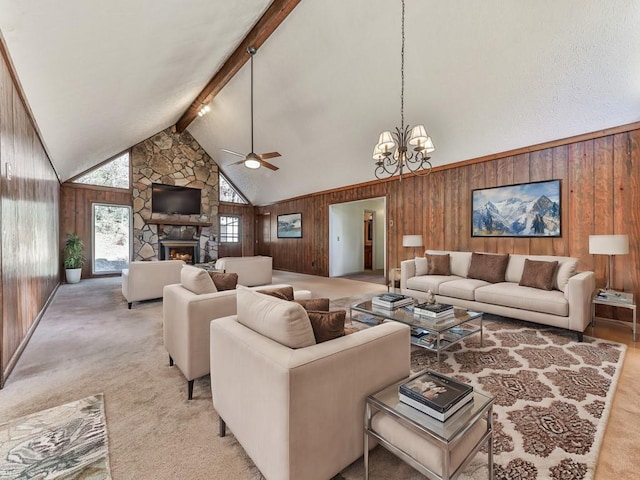 living room with beamed ceiling, wood walls, and a fireplace