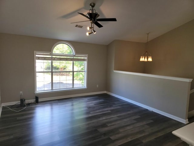 unfurnished room with visible vents, ceiling fan, dark wood-type flooring, and baseboards