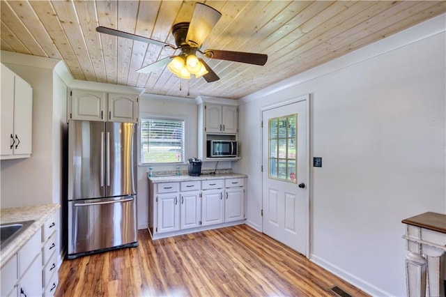 233 S Spring Rd, Eatonton, GA 31024 - kitchen with appliances with stainless steel finishes, wooden ceiling, light wood-style floors, a ceiling fan, and white cabinets