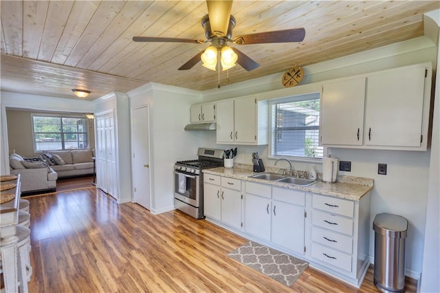 233 S Spring Rd, Eatonton, GA 31024 - kitchen featuring gas stove, under cabinet range hood, wood ceiling, white cabinets, and light wood-type flooring