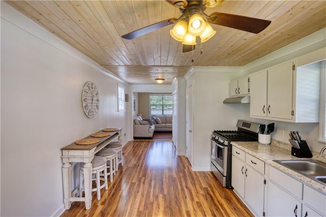 233 S Spring Rd, Eatonton, GA 31024 - kitchen featuring gas stove, under cabinet range hood, wood ceiling, ornamental molding, and ceiling fan