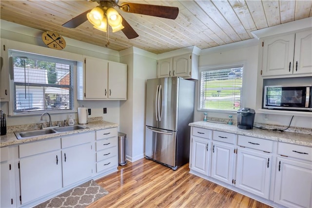 233 S Spring Rd, Eatonton, GA 31024 - kitchen with stainless steel appliances, wooden ceiling, light wood finished floors, light countertops, and white cabinetry