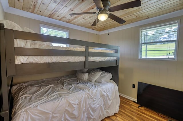 233 S Spring Rd, Eatonton, GA 31024 - bedroom with multiple windows, wood finished floors, wooden ceiling, and ceiling fan