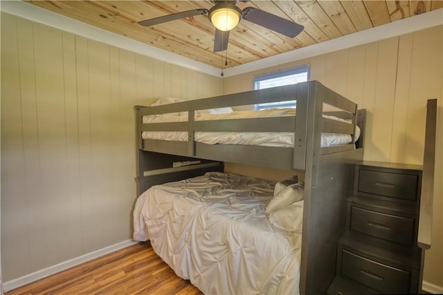 233 S Spring Rd, Eatonton, GA 31024 - bedroom with wood ceiling, wood finished floors, ceiling fan, and wood walls