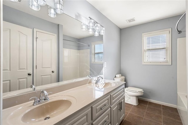 full bathroom featuring tile patterned flooring, bathtub / shower combination, vanity, and toilet