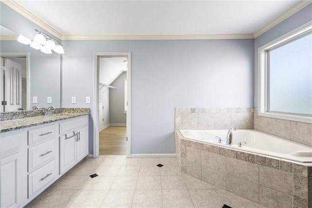 bathroom featuring vanity, a relaxing tiled tub, tile patterned floors, and ornamental molding