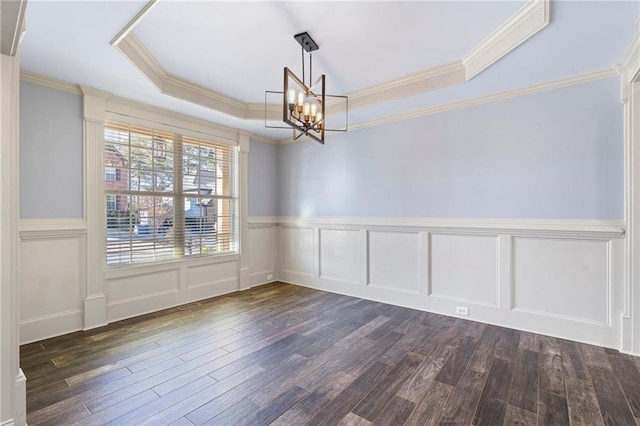 unfurnished dining area with a raised ceiling, dark hardwood / wood-style flooring, ornamental molding, and a notable chandelier