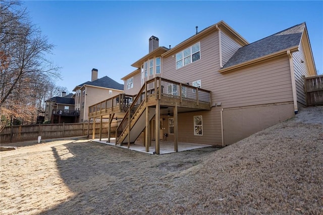 rear view of house featuring a deck and a patio area