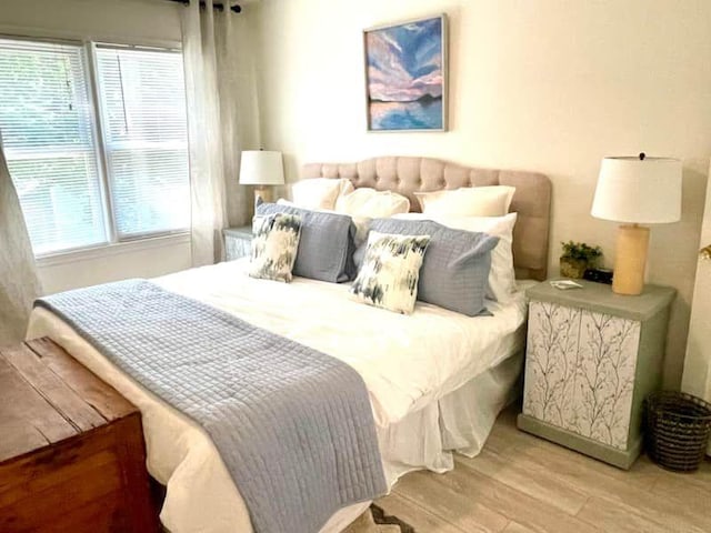 bedroom featuring multiple windows and light hardwood / wood-style floors