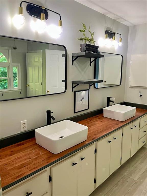 bathroom with vanity and hardwood / wood-style flooring