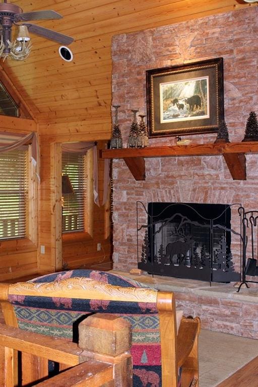 living room featuring vaulted ceiling, a fireplace, wood-type flooring, and wooden ceiling