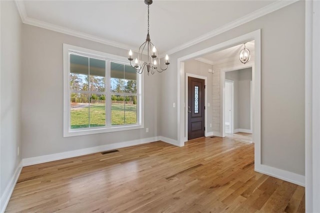 unfurnished dining area with a notable chandelier, baseboards, and light wood-style floors