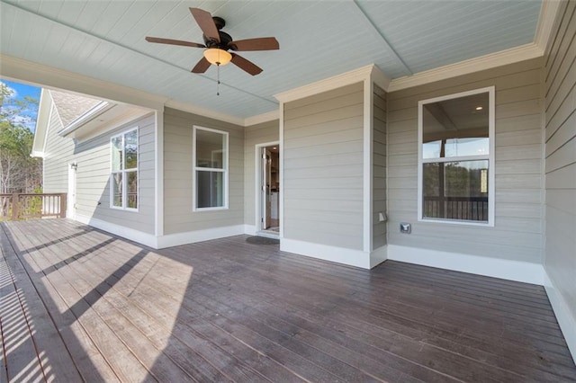 wooden terrace with a ceiling fan