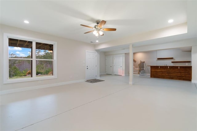 interior space featuring baseboards, recessed lighting, ceiling fan, stairs, and concrete flooring