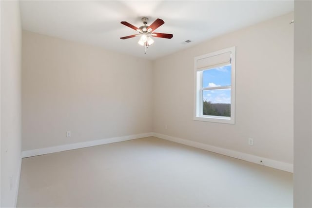 unfurnished room featuring baseboards, visible vents, and ceiling fan