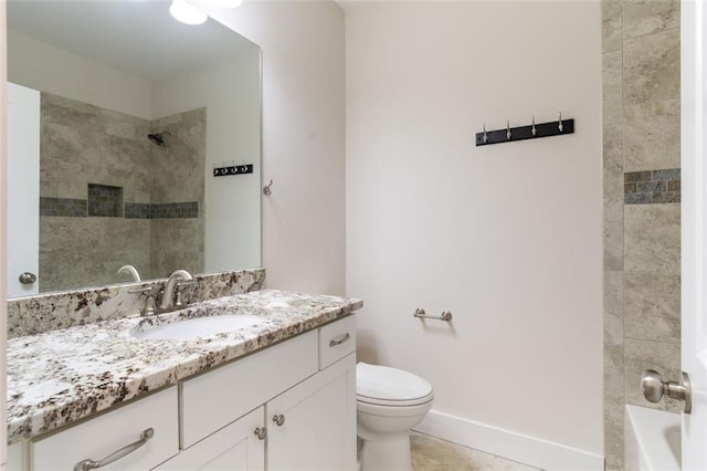 bathroom featuring vanity, tile patterned floors, toilet, and baseboards