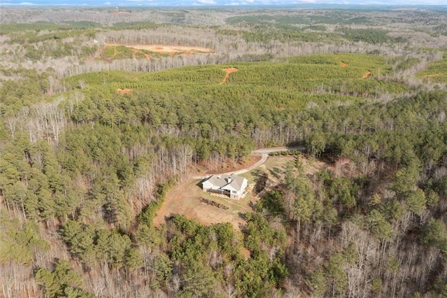 drone / aerial view with a wooded view