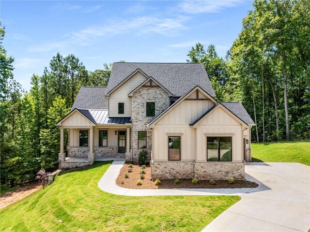 7262 Creekside Way, Jefferson, GA 30549 - view of front of home with board and batten siding, brick siding, and roof with shingles