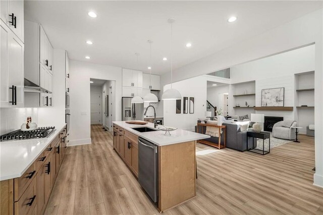 7262 Creekside Way, Jefferson, GA 30549 - kitchen with stainless steel appliances, light wood-type flooring, a center island with sink, light countertops, and recessed lighting