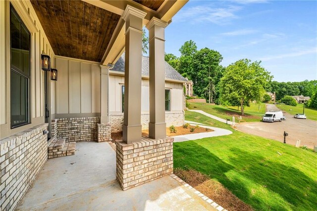 7262 Creekside Way, Jefferson, GA 30549 - back of property with a balcony, a patio area, a yard, and stone siding