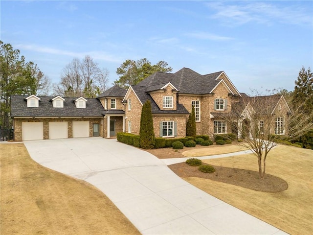 view of front of house with concrete driveway, brick siding, and an attached garage