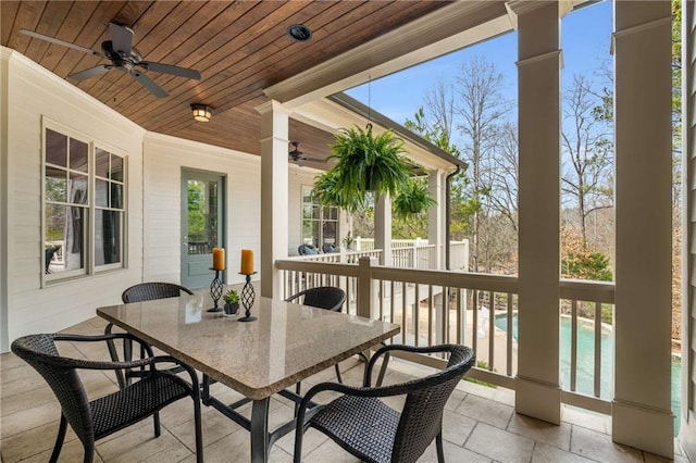 exterior space with ceiling fan, outdoor dining space, fence, and an outdoor pool