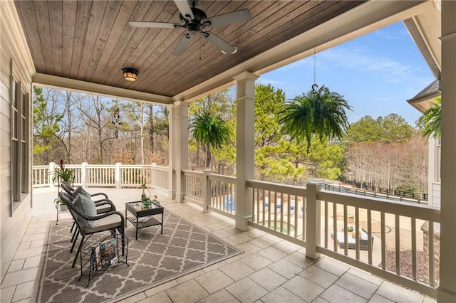 exterior space featuring wood ceiling and ceiling fan