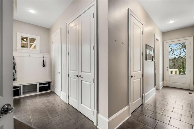 mudroom with recessed lighting and baseboards