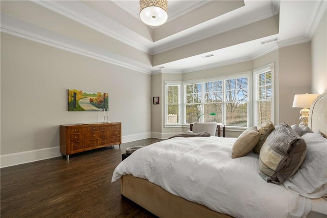 bedroom with ornamental molding, a tray ceiling, dark wood-style flooring, and visible vents