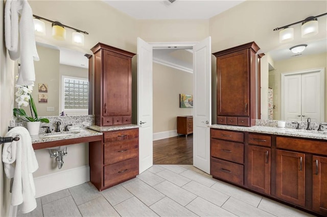 full bathroom featuring baseboards and a sink