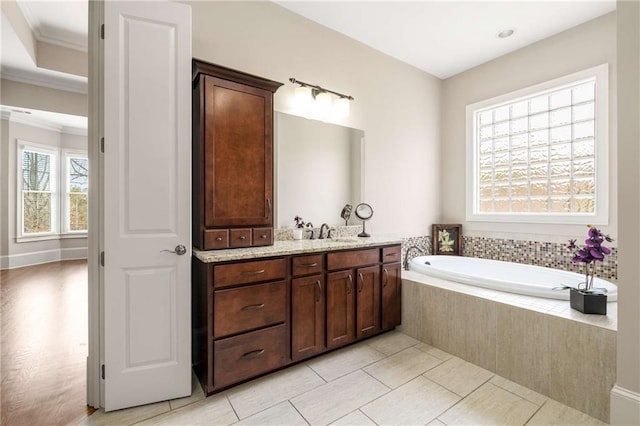 full bath with tile patterned flooring, crown molding, vanity, and a bath