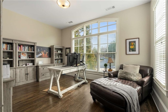 office with dark wood-style flooring, visible vents, and baseboards