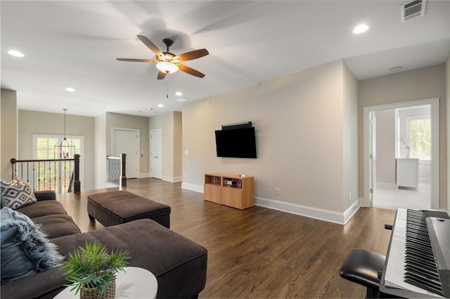 living area with recessed lighting, visible vents, baseboards, and wood finished floors