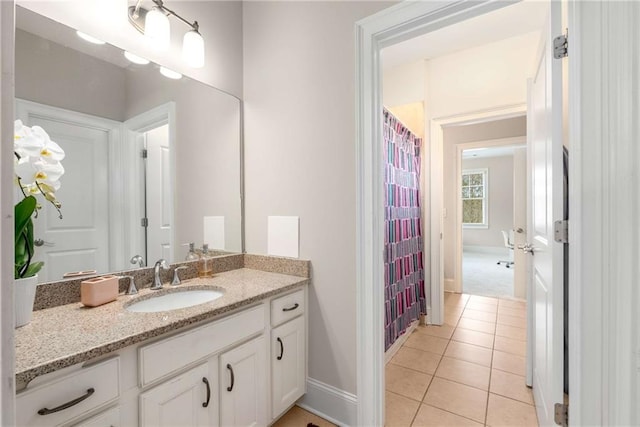 bathroom featuring tile patterned flooring, a shower with curtain, vanity, and baseboards