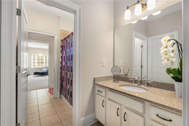 bathroom with tile patterned flooring, vanity, and baseboards