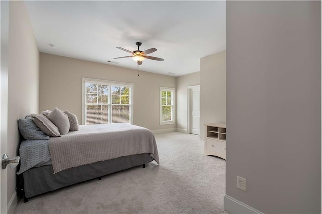 bedroom with a ceiling fan, baseboards, and carpet flooring