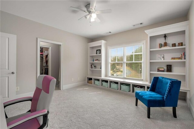 interior space with visible vents, baseboards, and ceiling fan