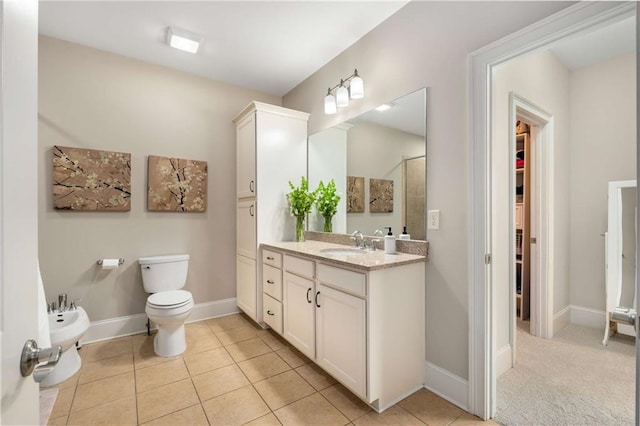 full bath with a bidet, vanity, tile patterned flooring, baseboards, and walk in shower