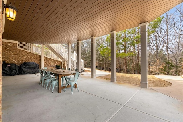 view of patio / terrace with stairs, outdoor dining space, and area for grilling