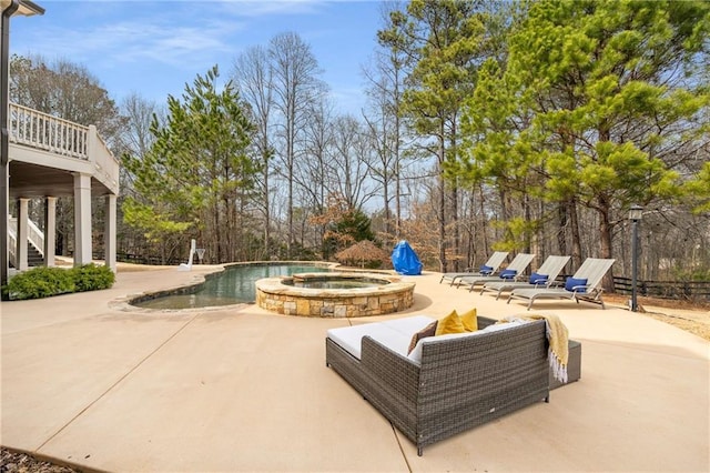 view of pool featuring a patio area, a pool with connected hot tub, and stairs