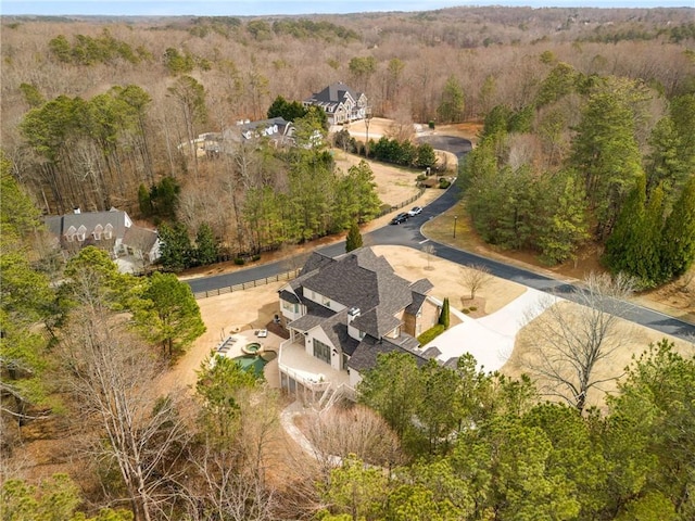 aerial view featuring a wooded view