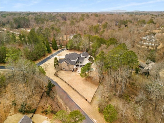 birds eye view of property featuring a view of trees