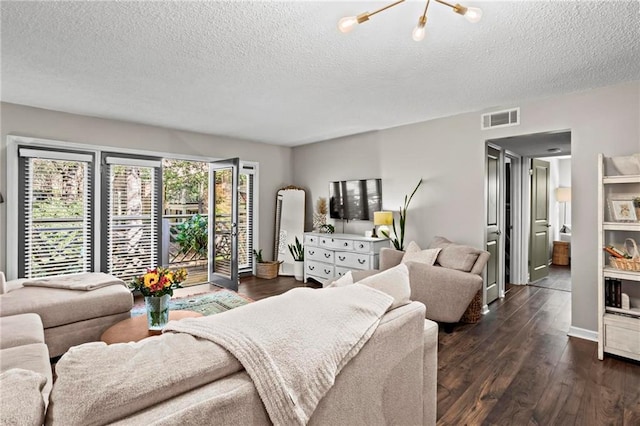 living room featuring dark hardwood / wood-style floors and a textured ceiling